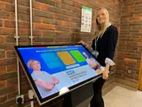Staff member with the interactive screen 