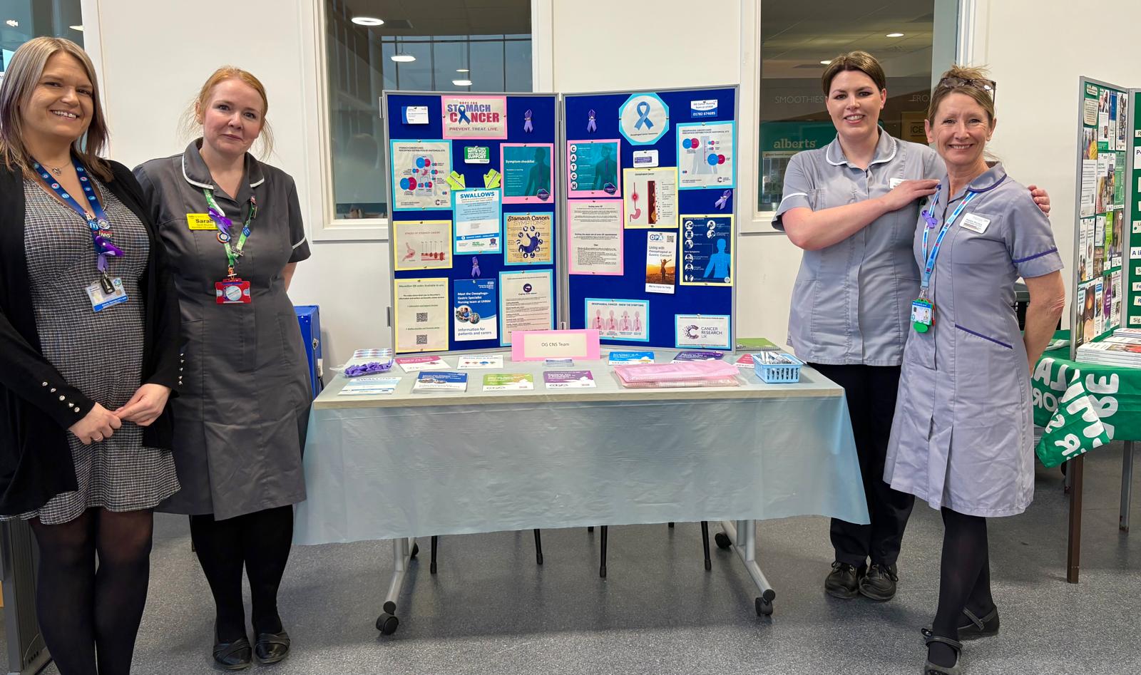 Cancer CNS team standing with their awareness stand