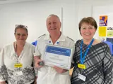 Mick Hibbs receiving his award with Chief Nurse ann-marie riley 
